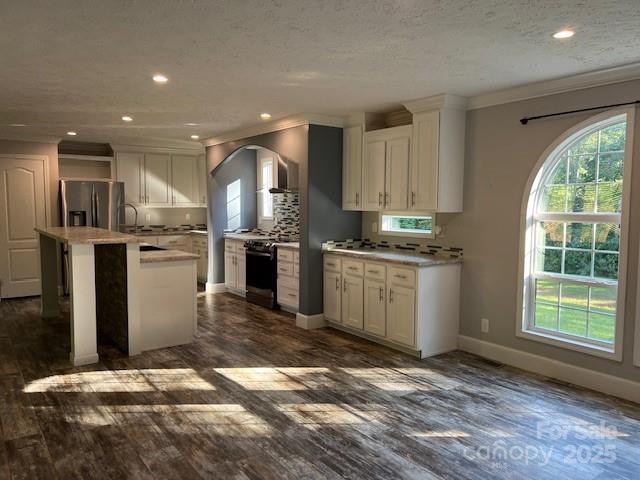 a kitchen with stainless steel appliances granite countertop a stove a sink and a refrigerator