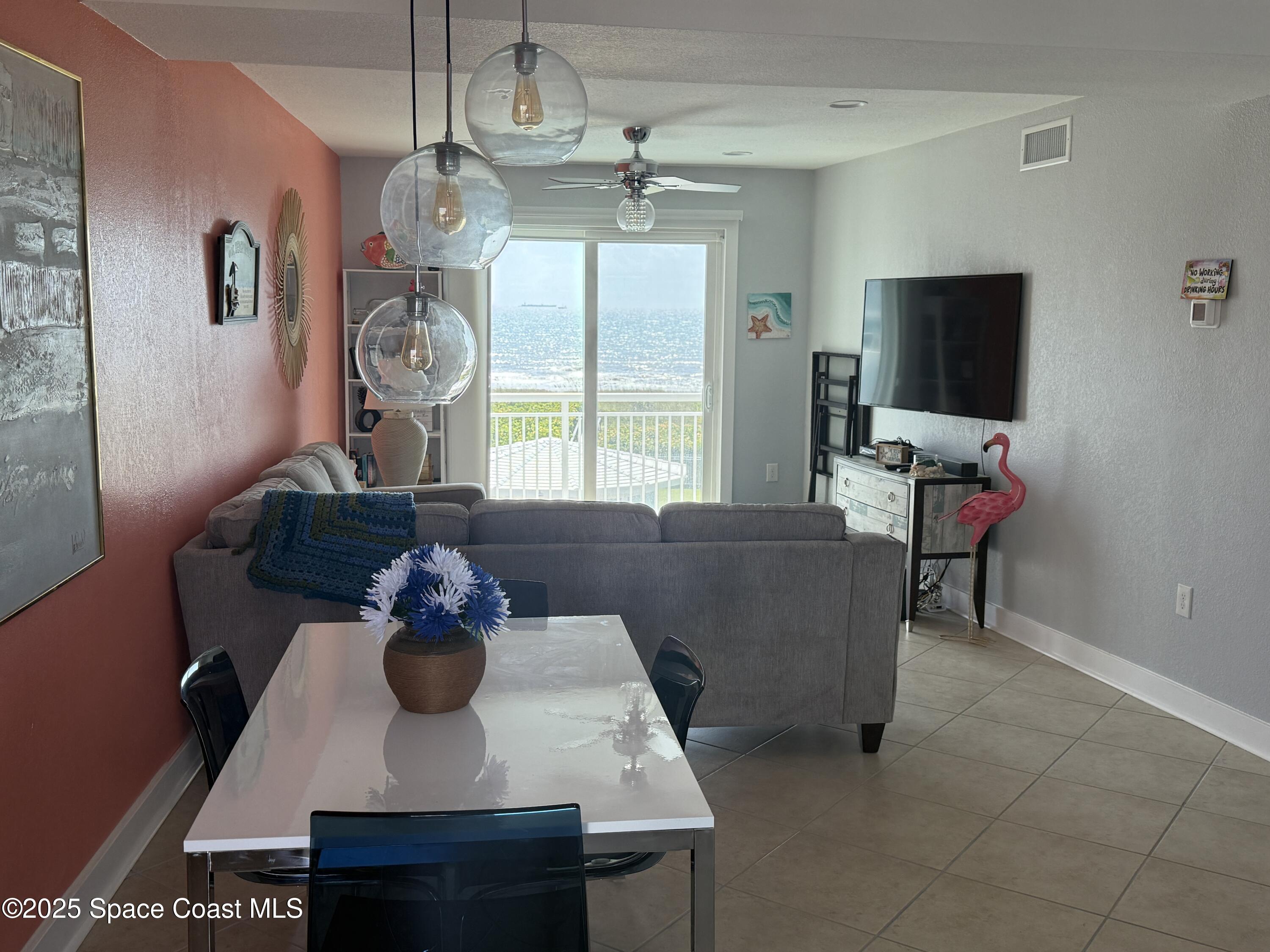 4000 Ocean Beach Boulevard, Unit 4F Cocoa Beach, FL 32931 - Photo 12 of 12 a living room with furniture and a flat screen tv