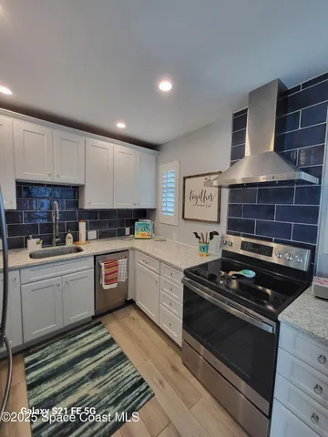 a kitchen with a stove a sink and a refrigerator