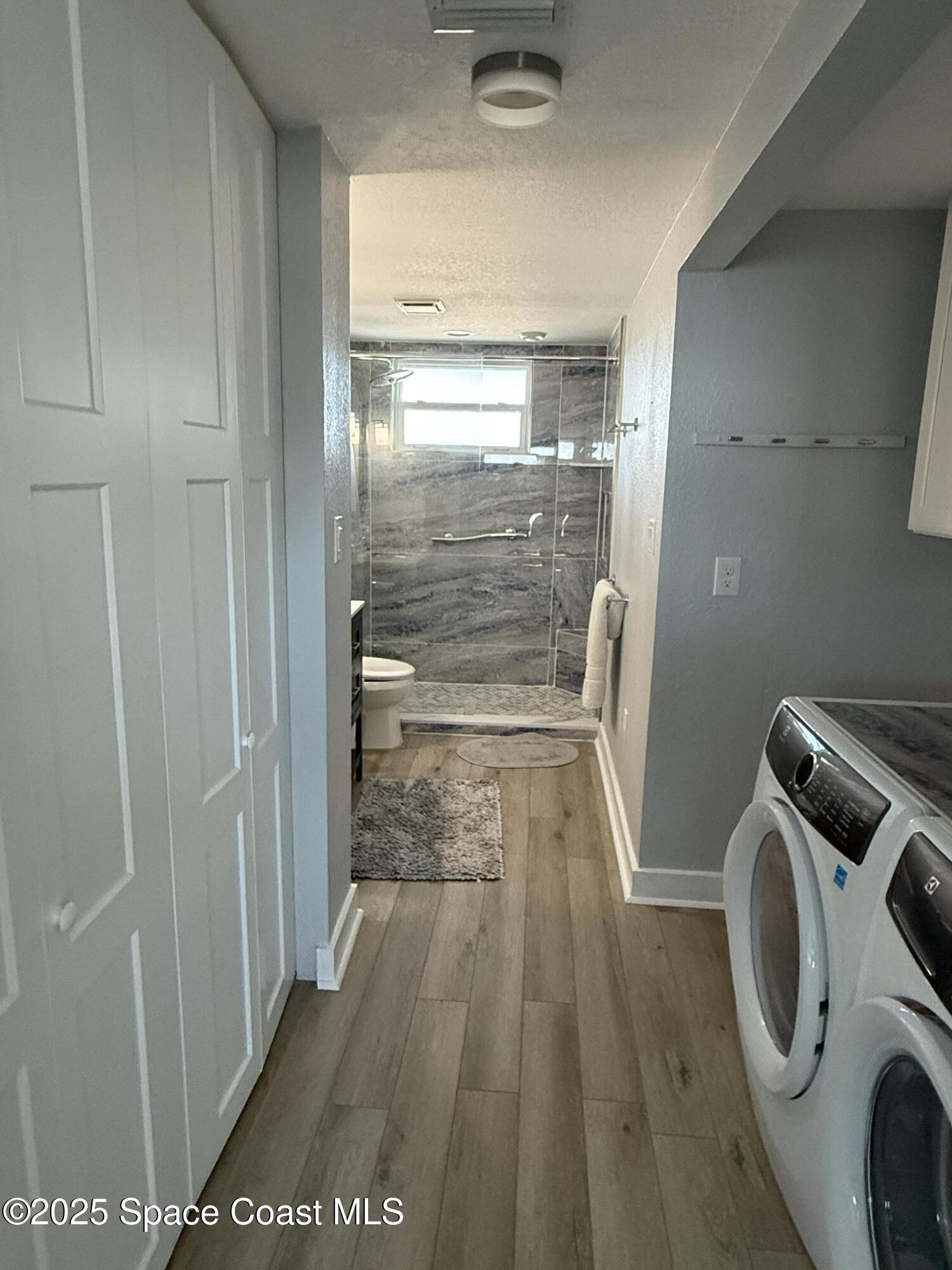 4000 Ocean Beach Boulevard, Unit 4F Cocoa Beach, FL 32931 - Photo 7 of 12 a view of storage and utility room with washer and dryer