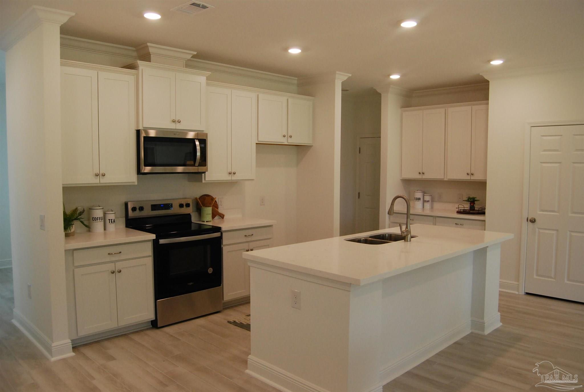7791 Piper Circle Milton, FL 32583 - Photo 3 of 4 a kitchen that has a sink and a stove in it
