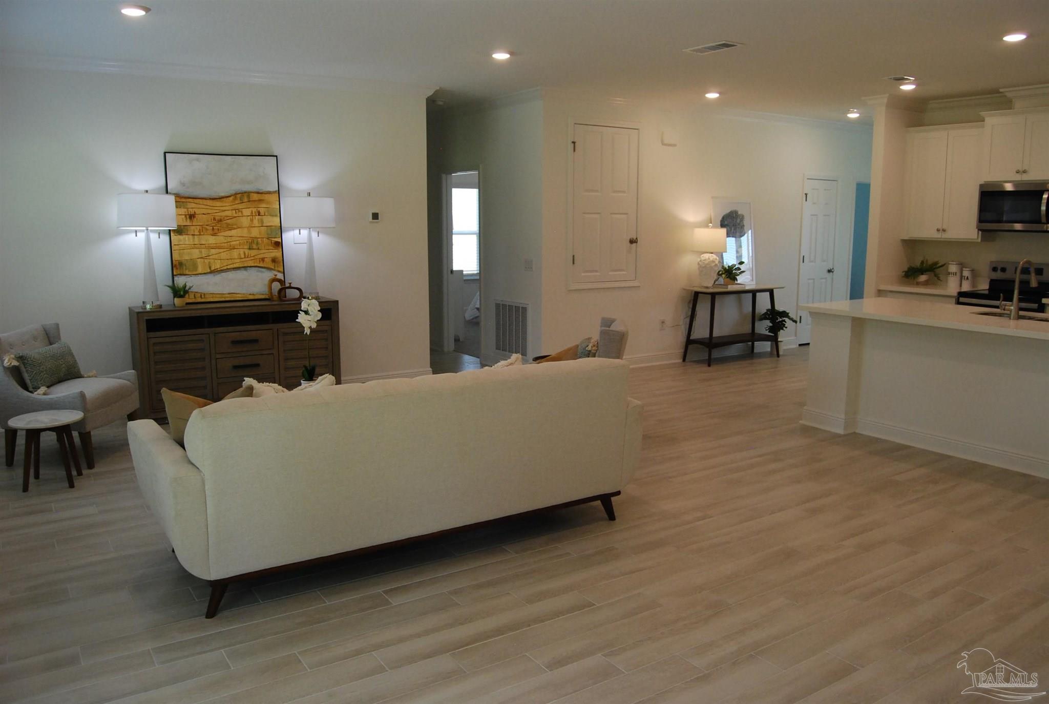 7791 Piper Circle Milton, FL 32583 - Photo 4 of 4 a living room with furniture and a flat screen tv