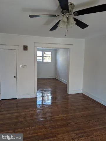 a view of livingroom with hardwood floor and a ceiling fan