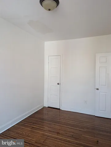 a view of an empty room and wooden floor