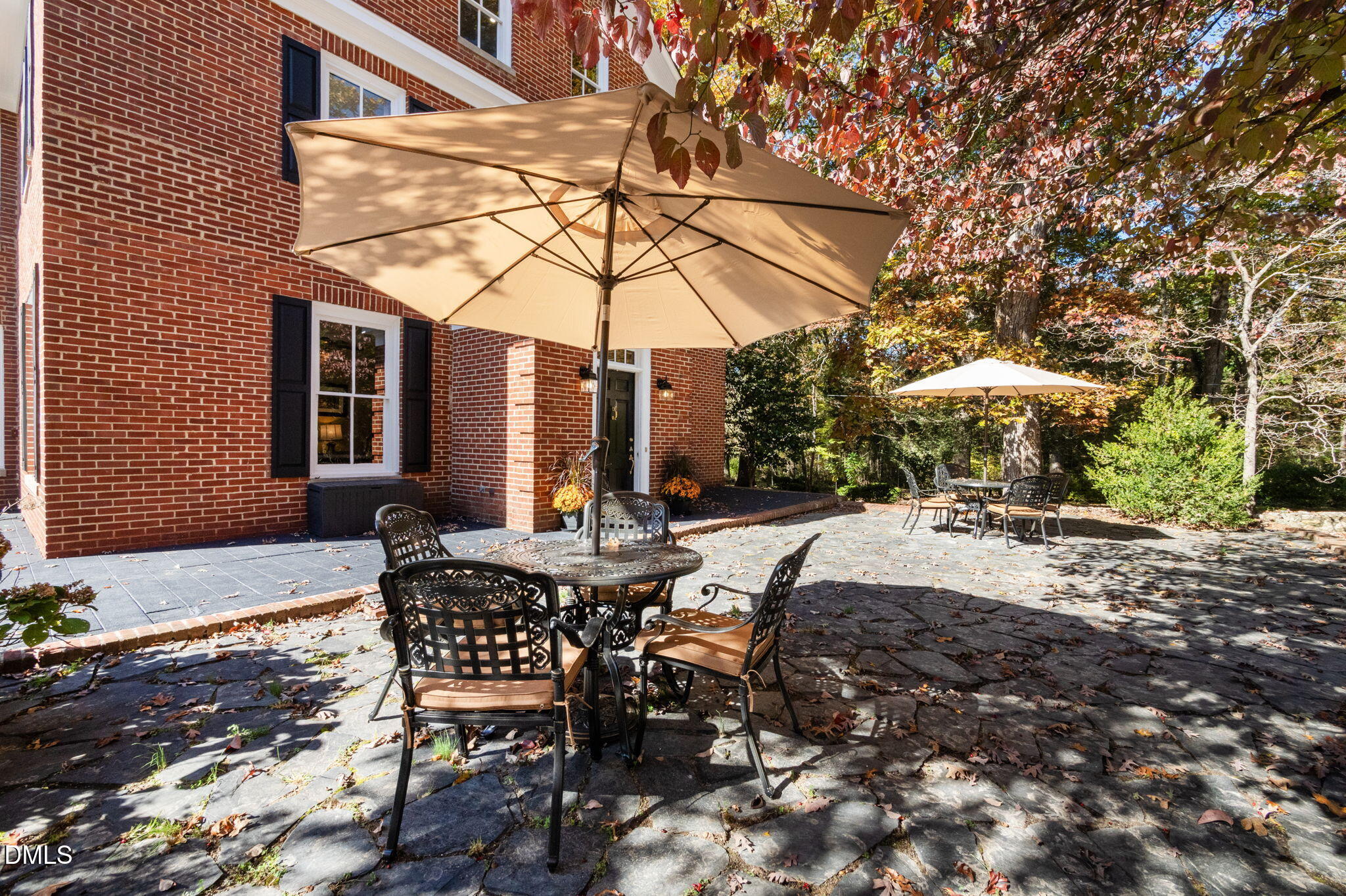7891 Boston Road Roxboro, NC 27574 - Photo 7 of 94 a view of a patio with a table and chairs under an umbrella