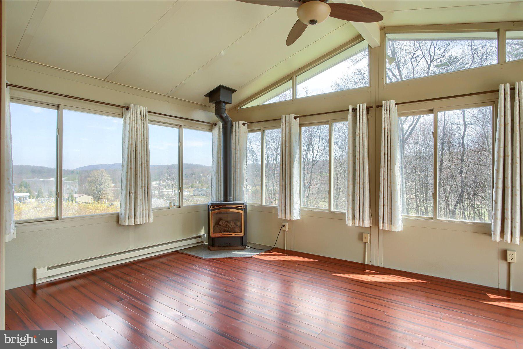 62 Tapeworm Road New Bloomfield, PA 17068 - Photo 15 of 40 Sunroom with propane stove.