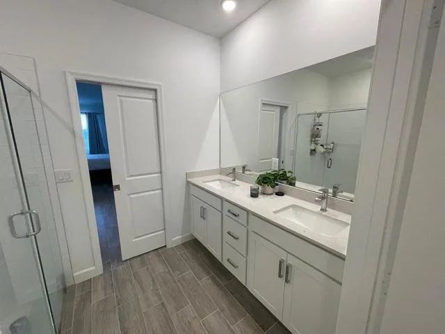 a bathroom with a double vanity sink and mirror
