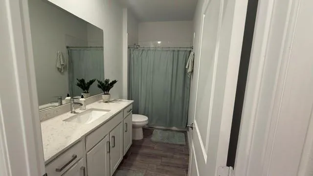 a bedroom with a bed and a wooden floor