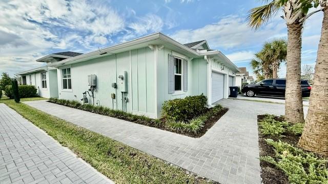 1353 Haywagon Tr. Loxahatchee, FL 33470 - Photo 20 of 34 a front view of a house with garden