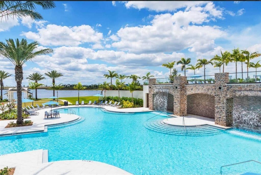 1353 Haywagon Tr. Loxahatchee, FL 33470 - Photo 22 of 34 a view of swimming pool with outdoor seating and city view
