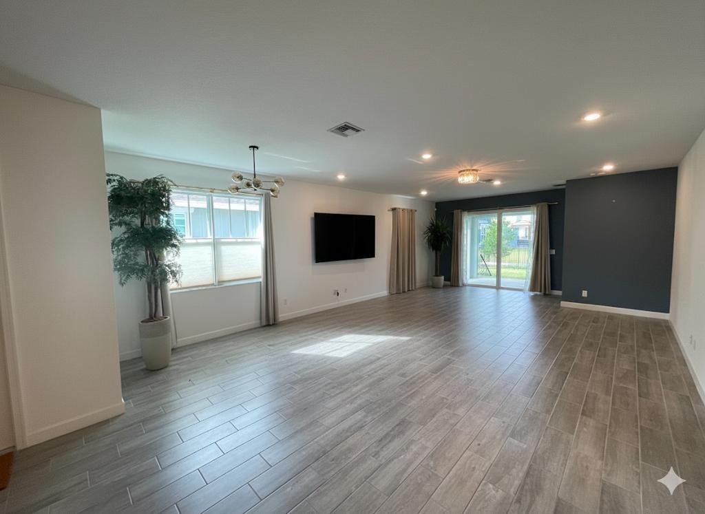 1353 Haywagon Tr. Loxahatchee, FL 33470 - Photo 6 of 34 an empty room with wooden floor and windows