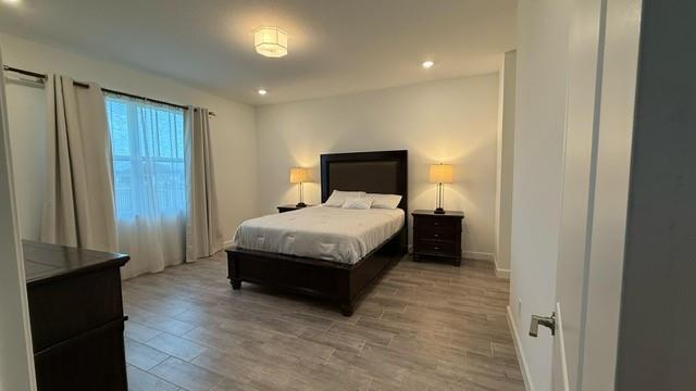 1353 Haywagon Tr. Loxahatchee, FL 33470 - Photo 7 of 34 a bedroom with a bed and wooden floor