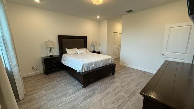 1353 Haywagon Tr. Loxahatchee, FL 33470 - Photo 8 of 34 a bedroom with a bed and wooden floor