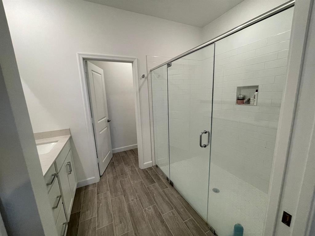 1353 Haywagon Tr. Loxahatchee, FL 33470 - Photo 10 of 34 a bathroom with a shower and a wooden floor