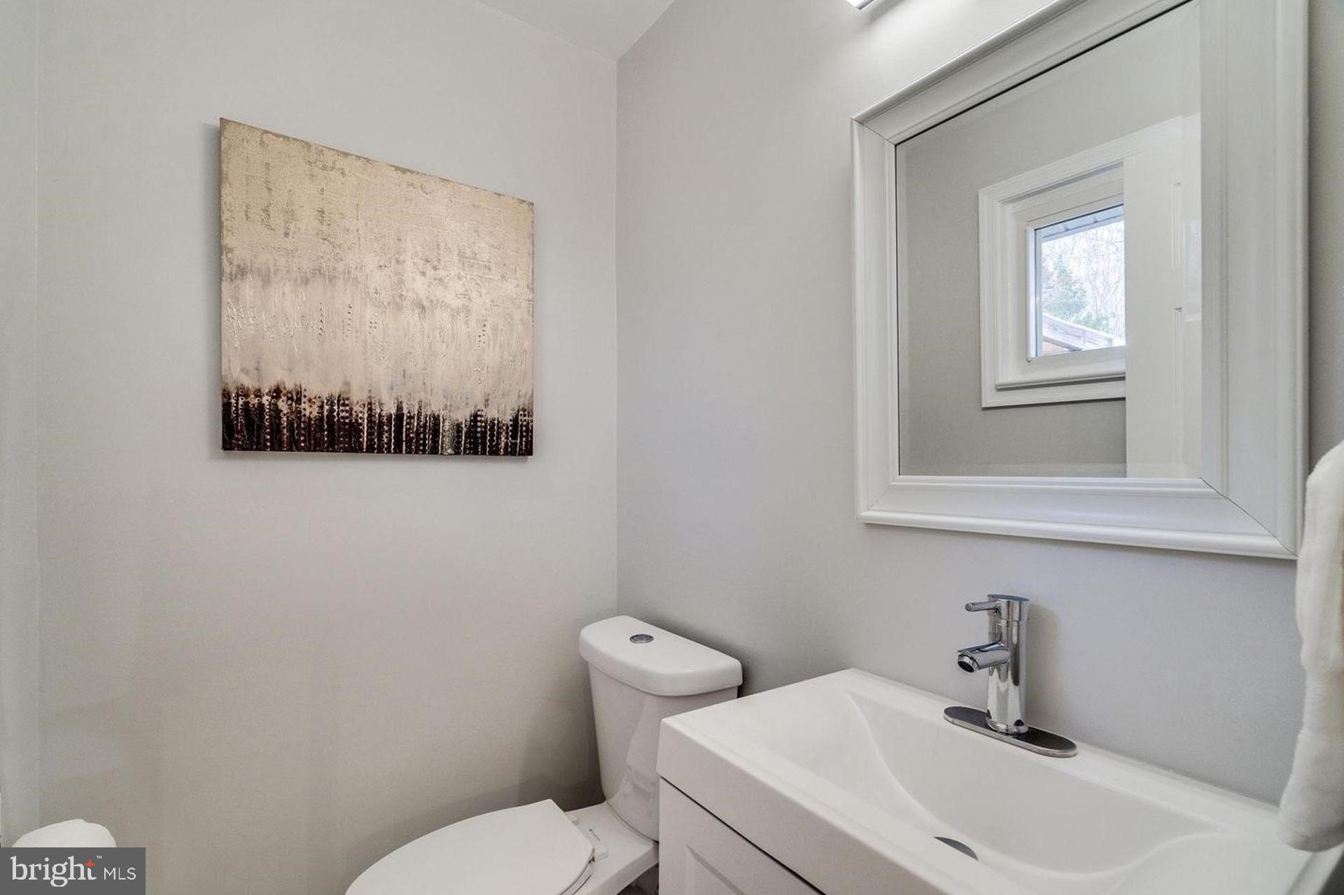 4518 Gage Road Alexandria, VA 22309 - Photo 18 of 42 a bathroom with a toilet a sink and mirror