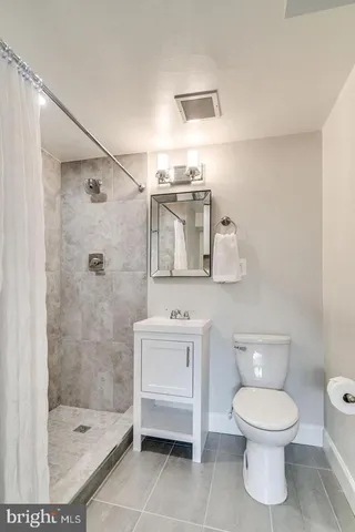 a bathroom with a toilet sink and shower