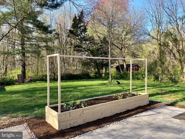 a wooden bench sitting in backside of a house