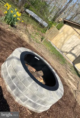 a view of a house with backyard sitting area and garden