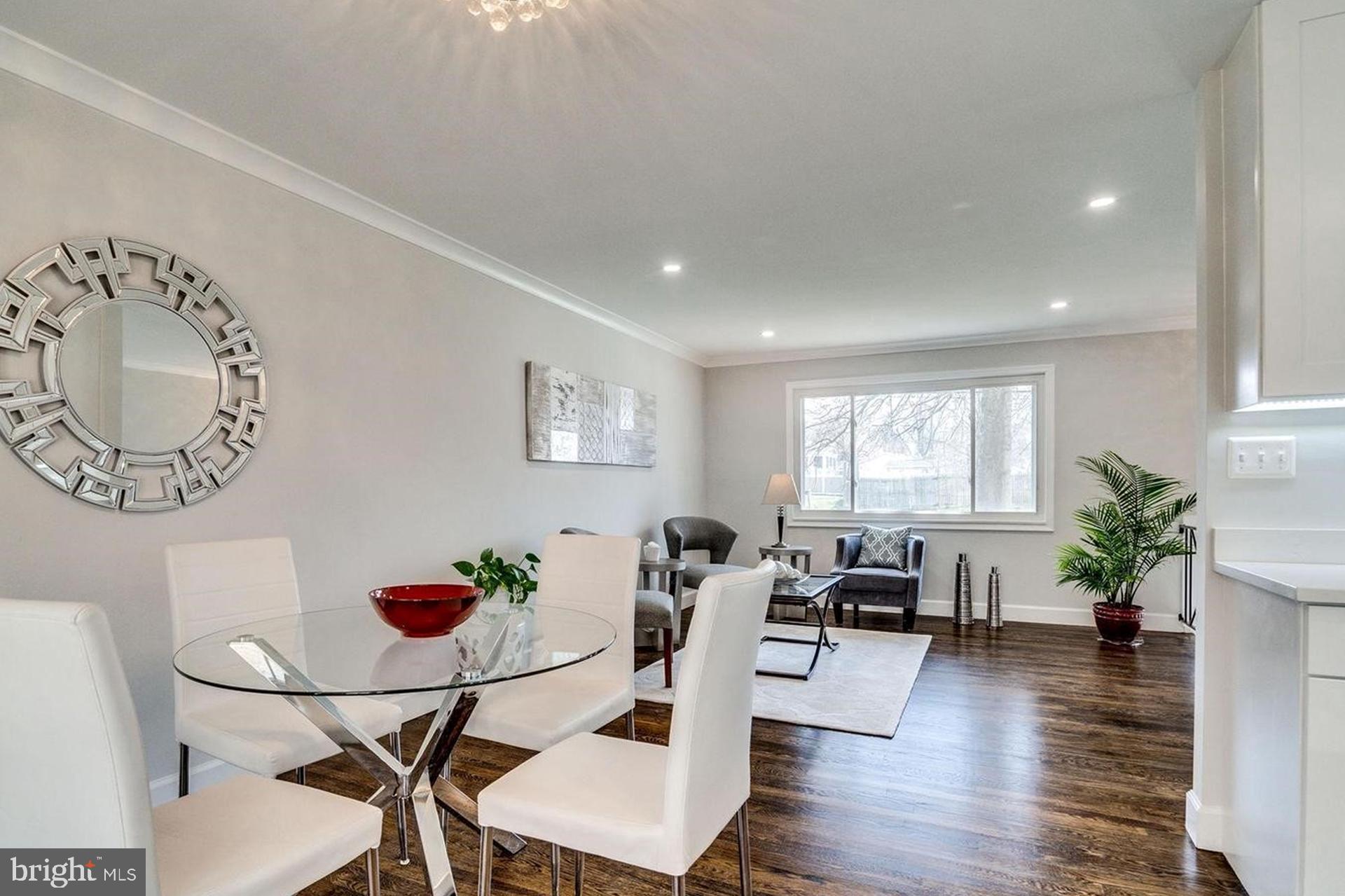 4518 Gage Road Alexandria, VA 22309 - Photo 9 of 42 a living room with furniture potted plant and a large window