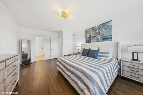 a spacious bedroom with a bed and painting on the wall