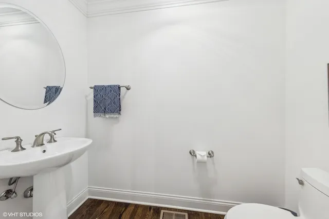 a bathroom with a sink mirror and toilet