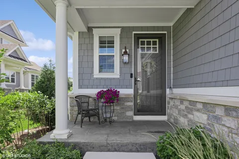 a front view of a house with outdoor seating