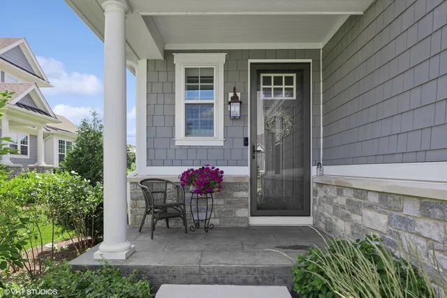 a front view of a house with outdoor seating