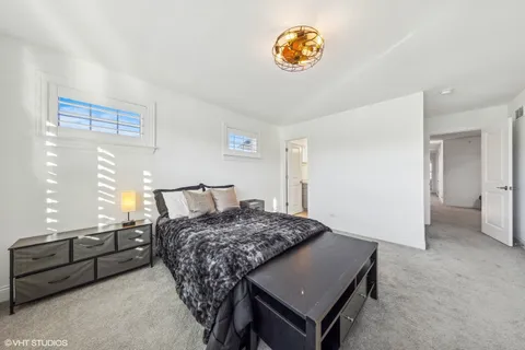 a bedroom with a bed and a table in it