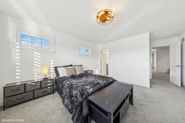 a bedroom with a bed and a table in it