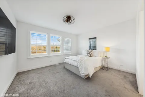 a spacious bedroom with a large bed and a window