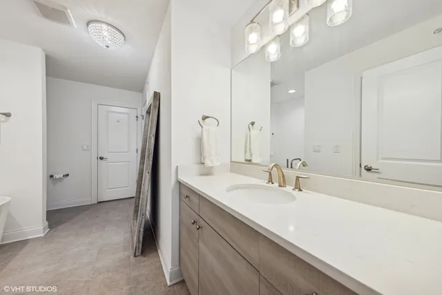 a bathroom with a sink a vanity and a mirror