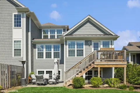 a front view of a house with a yard and potted plants
