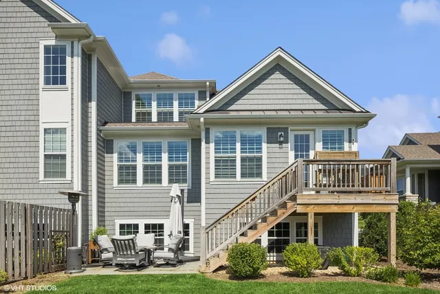 a front view of a house with a yard and potted plants