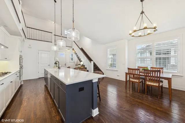 a kitchen with sink and wooden floor