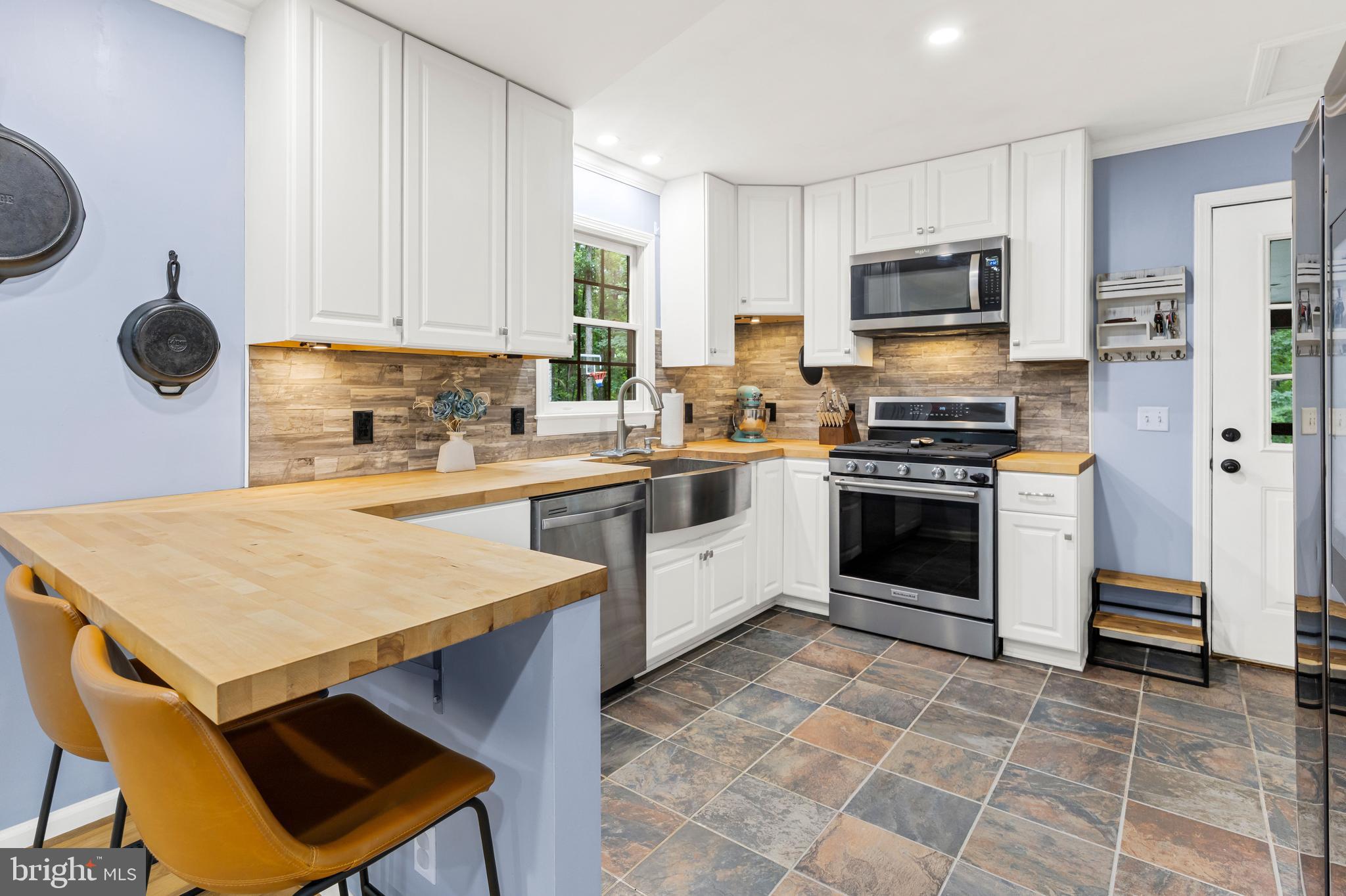 1425 Jacks Shop Road Rochelle, VA 22738 - Photo 16 of 56 a kitchen with a stove a sink and a microwave