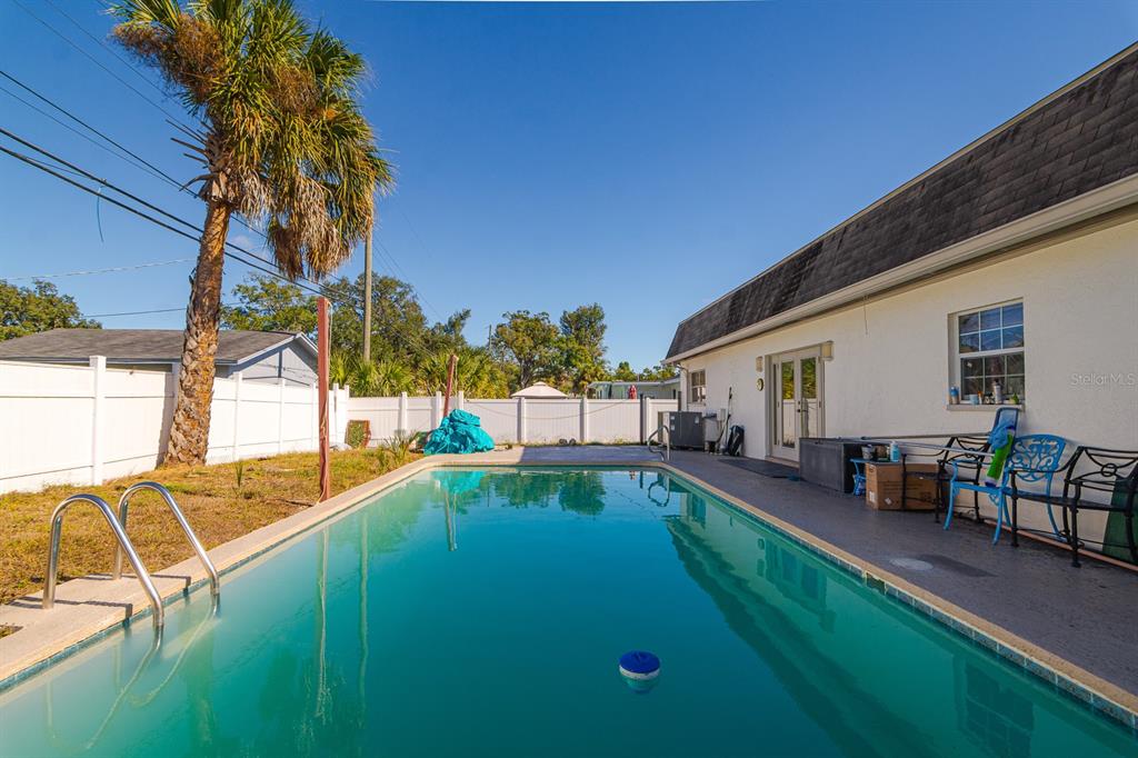 104 Druid Hills Road Temple Terrace, FL 33617 - Photo 18 of 22 swimming pool view with seating space