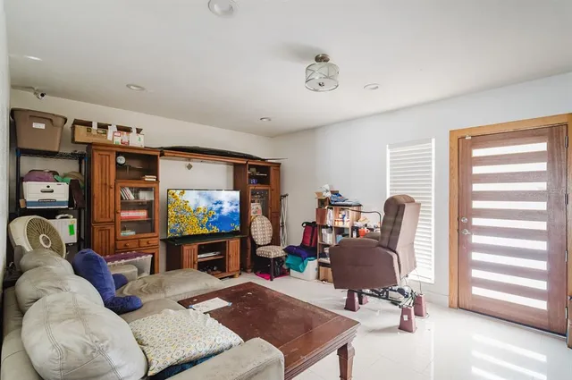a view of a livingroom with workspace and a window