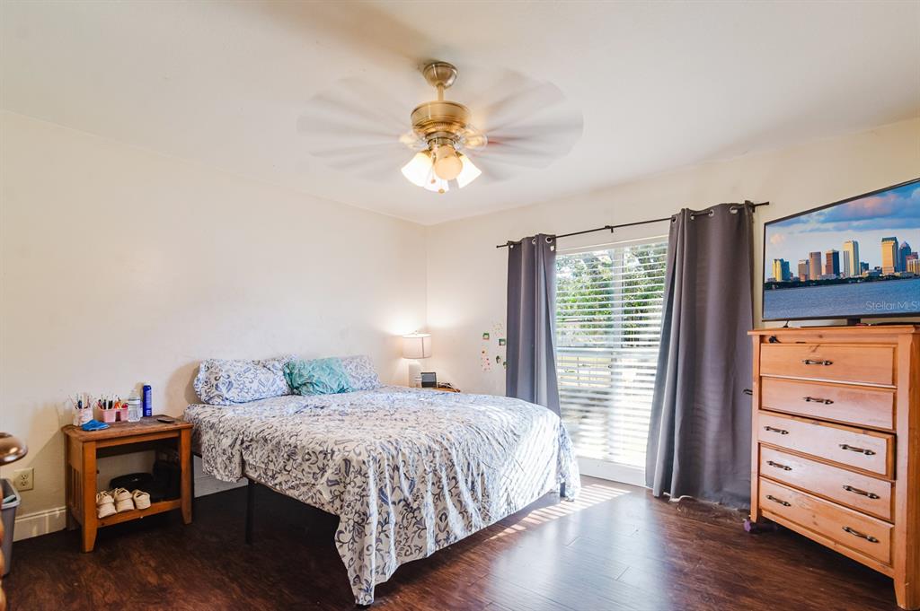 104 Druid Hills Road Temple Terrace, FL 33617 - Photo 8 of 22 a bedroom with a bed and a chandelier