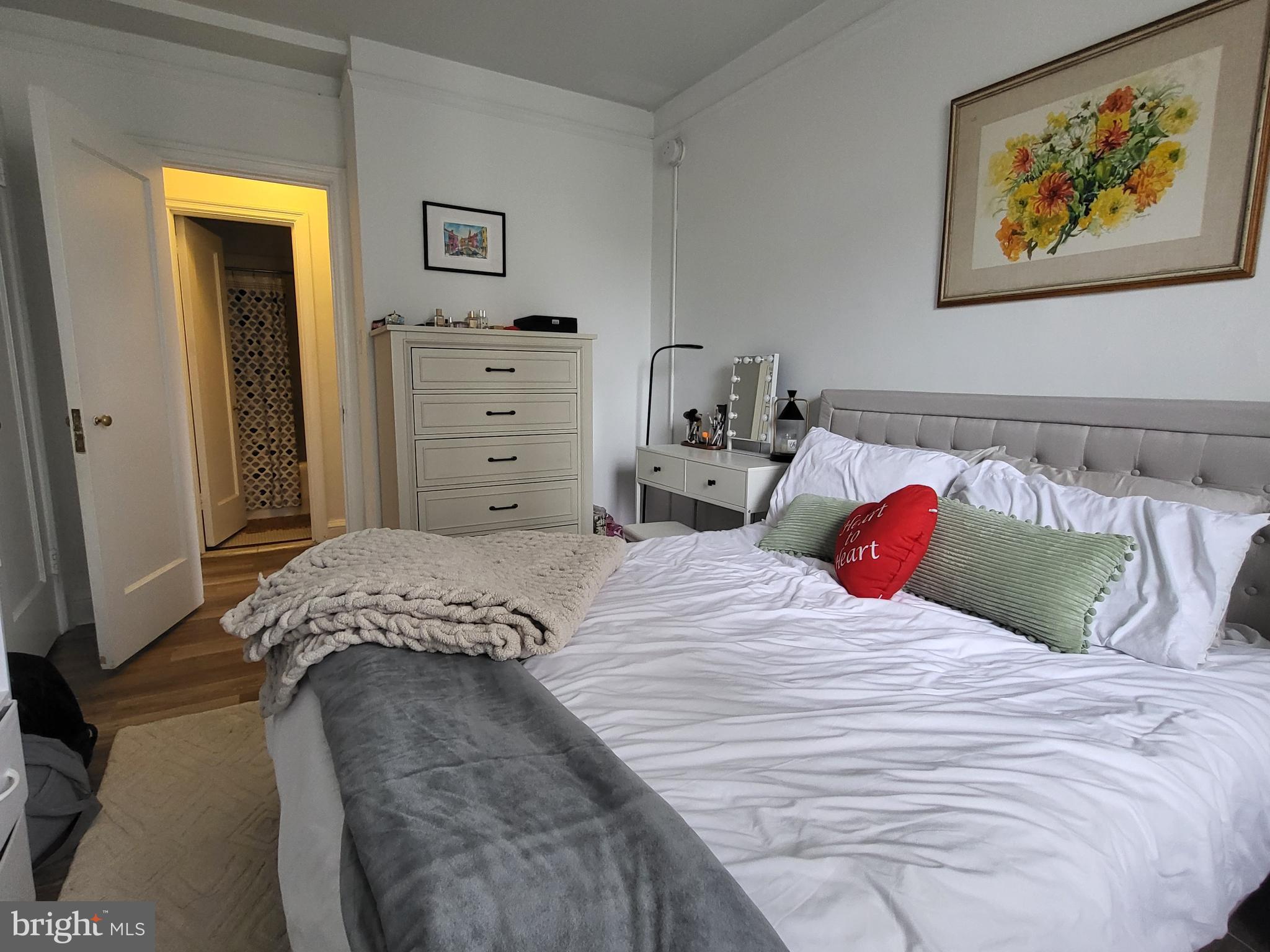2031 Locust Street, Unit 1503 Philadelphia, PA 19103 - Photo 13 of 24 a bedroom with a bed and a painting on the wall
