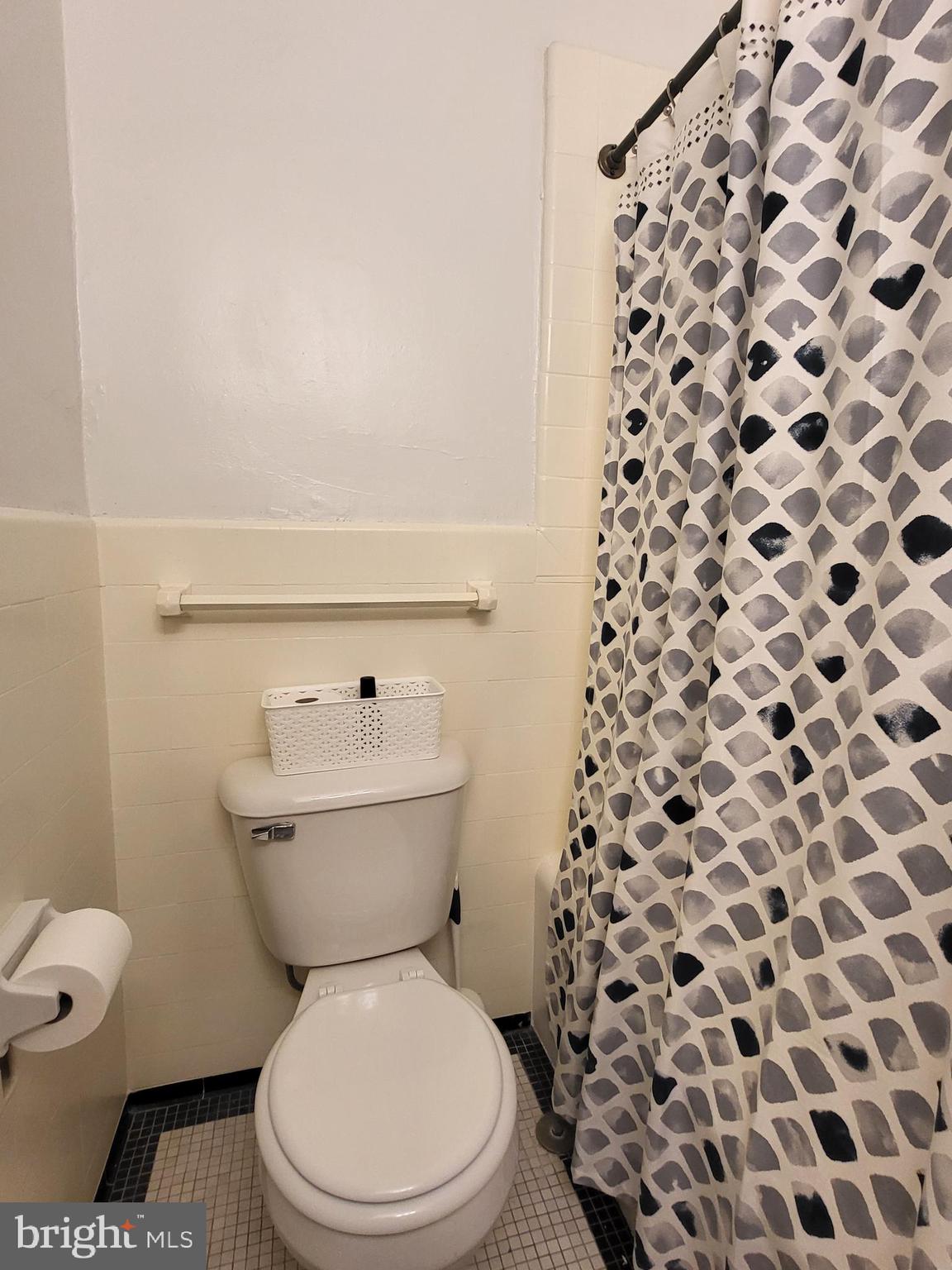 2031 Locust Street, Unit 1503 Philadelphia, PA 19103 - Photo 15 of 24 a white toilet sitting next to a shower curtain