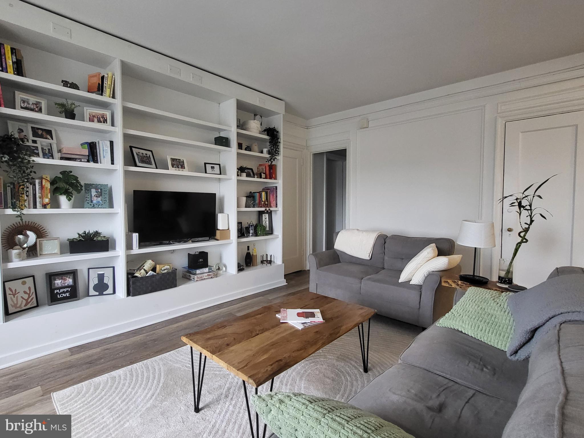 2031 Locust Street, Unit 1503 Philadelphia, PA 19103 - Photo 3 of 24 a living room with furniture and a flat screen tv