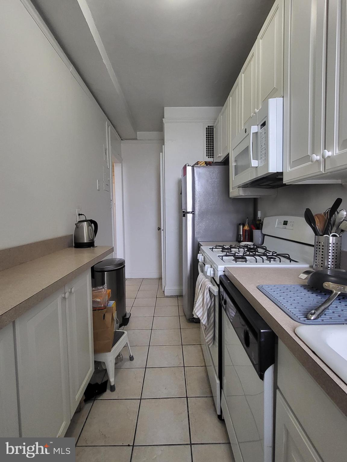 2031 Locust Street, Unit 1503 Philadelphia, PA 19103 - Photo 7 of 24 a kitchen with stainless steel appliances granite countertop a sink stove and refrigerator
