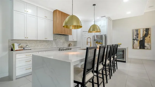 a kitchen with a dining table cabinets and a window