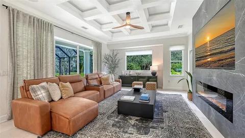 a living room with furniture fireplace and a large window