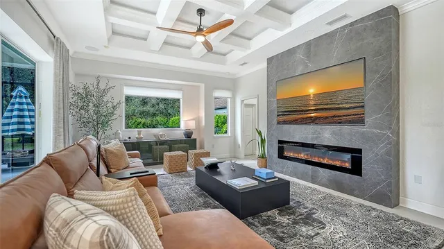 a living room with furniture a fireplace and a flat screen tv