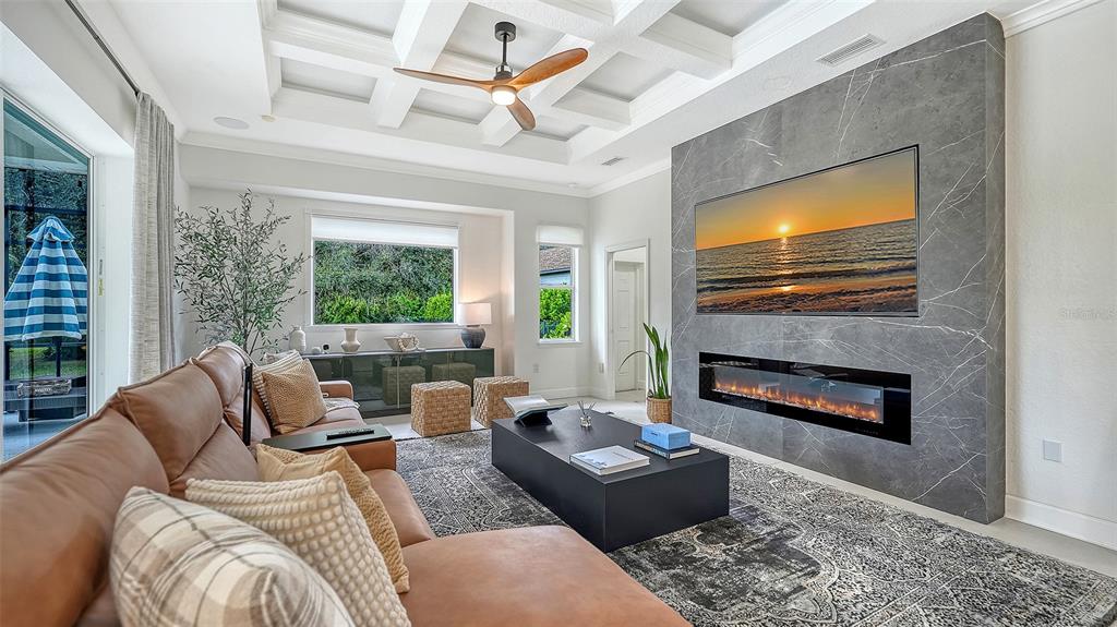 3415 162nd Avenue East Parrish, FL 34219 - Photo 15 of 49 a living room with furniture a fireplace and a flat screen tv