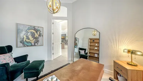 a view of a bedroom with workspace and a window