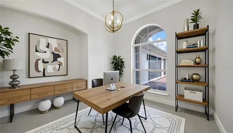 a view of a dining room with furniture a rug and wooden floor