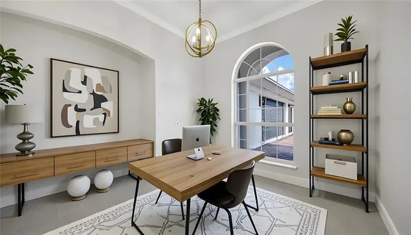 a view of a dining room with furniture a rug and wooden floor