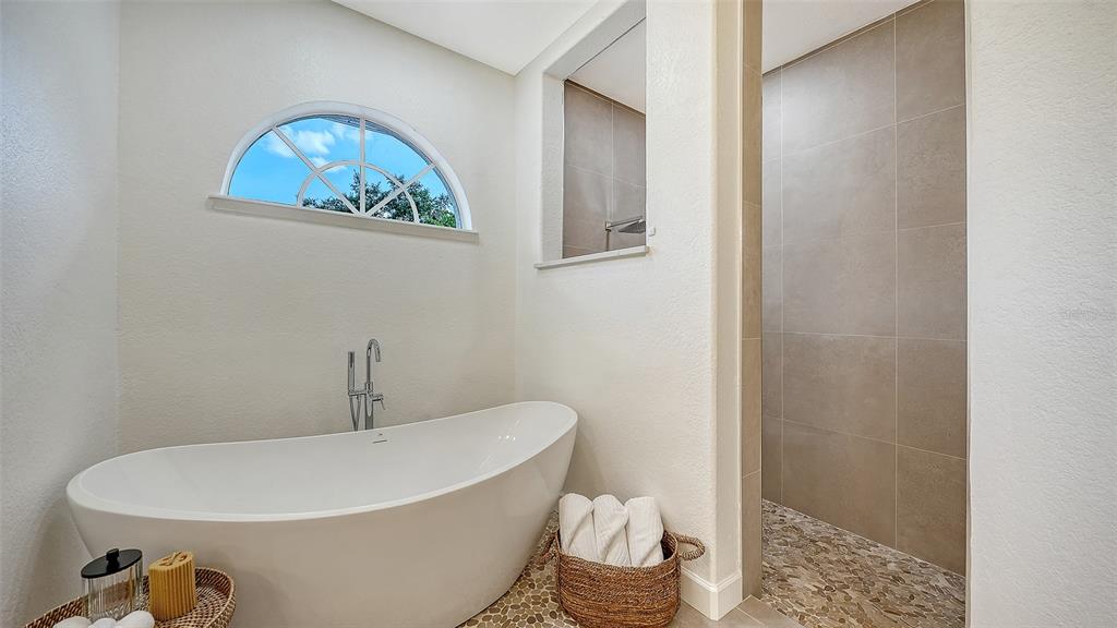 3415 162nd Avenue East Parrish, FL 34219 - Photo 29 of 49 a white bath tub sitting next to a white toilet and a shower